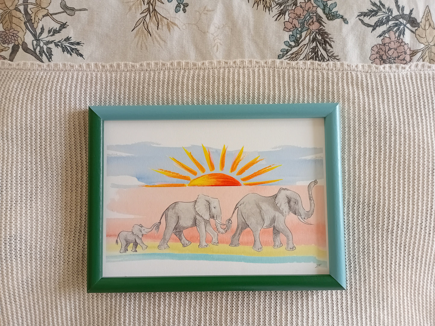 Elephant art print for children's gift and nursery. A family of three elephants walking with trunks in the air. Colourful. Made in UK.