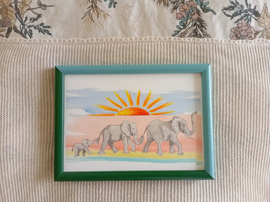 Elephant art print for children's gift and nursery. A family of three elephants walking with trunks in the air. Colourful. Made in UK.